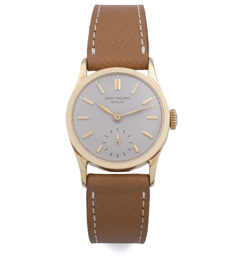 Patek Philippe Calatrava 96 watch with a beige leather strap and a minimalist grey dial.